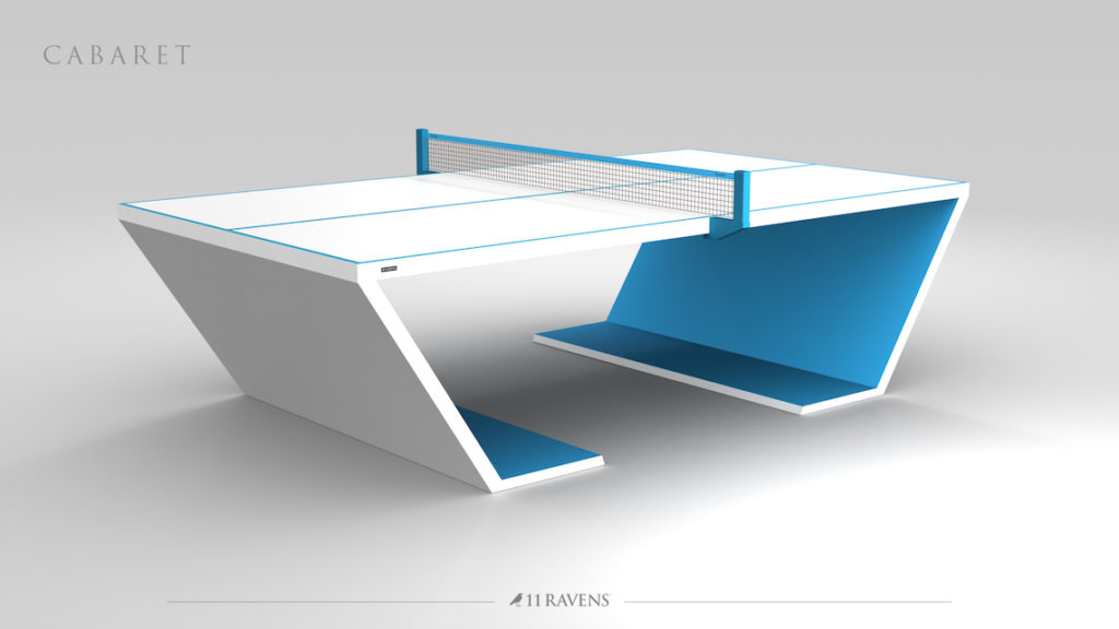 The Cabaret Ping Pong Table is a modern luxury game table featuring a sleek, angular design in white and blue. The net divides the geometric side panels, elegantly displaying the 11 Ravens brand name.