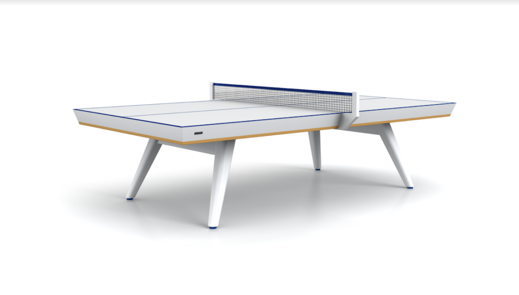 The Hamptons Ping Pong Table is a luxury setup with modern white design, elegant blue edges, mesh net, and sleek angled legs, creating a striking focal point against a plain white background.