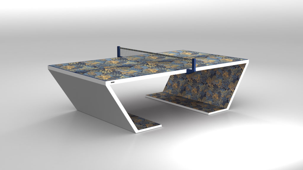 The Cabaret Ping Pong Table features a modern, angular base with a floral-patterned playing surface and sides. This luxurious table is complemented by a blue net and set against a plain gray background.