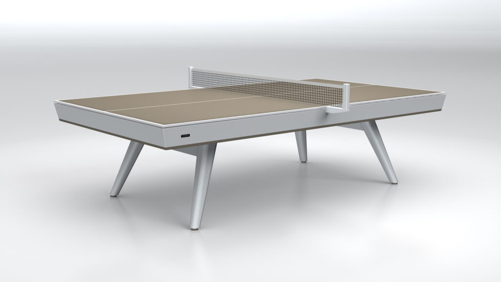 The Hamptons Ping Pong Table features a modern, minimalist design with a beige playing surface, white edges, angled white legs, and a net, all displayed against a plain white background.