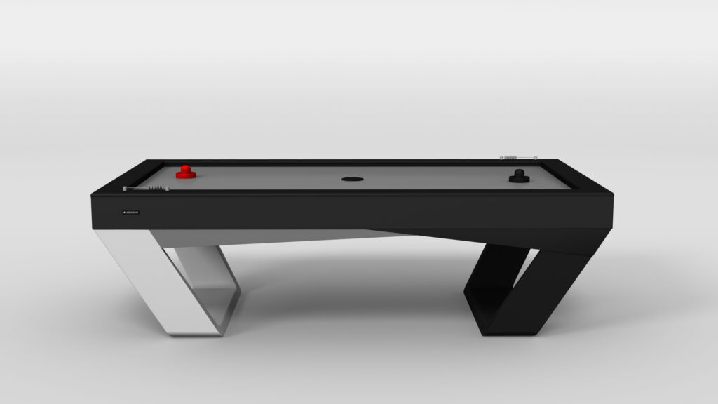 The Avettore Air Hockey Table showcases a sleek black and white geometric base and a modern gray surface, complemented by red and black strikers at each end.