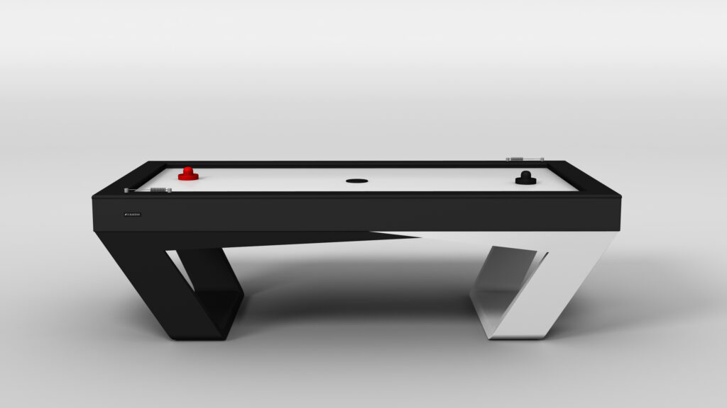 The Avettore Air Hockey Table features a modern black and white geometric base, a sleek white playing surface, and comes with red and black strikers for stylish play.