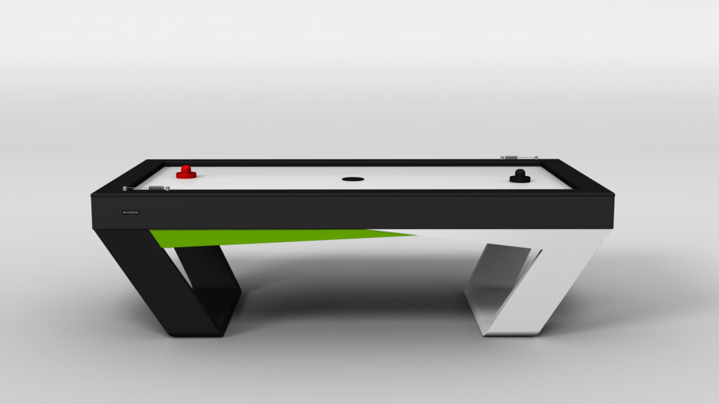 The Avettore Air Hockey Table boasts a modern angular design in black, white, and green, and comes with one red and one black paddle on the playing surface.
