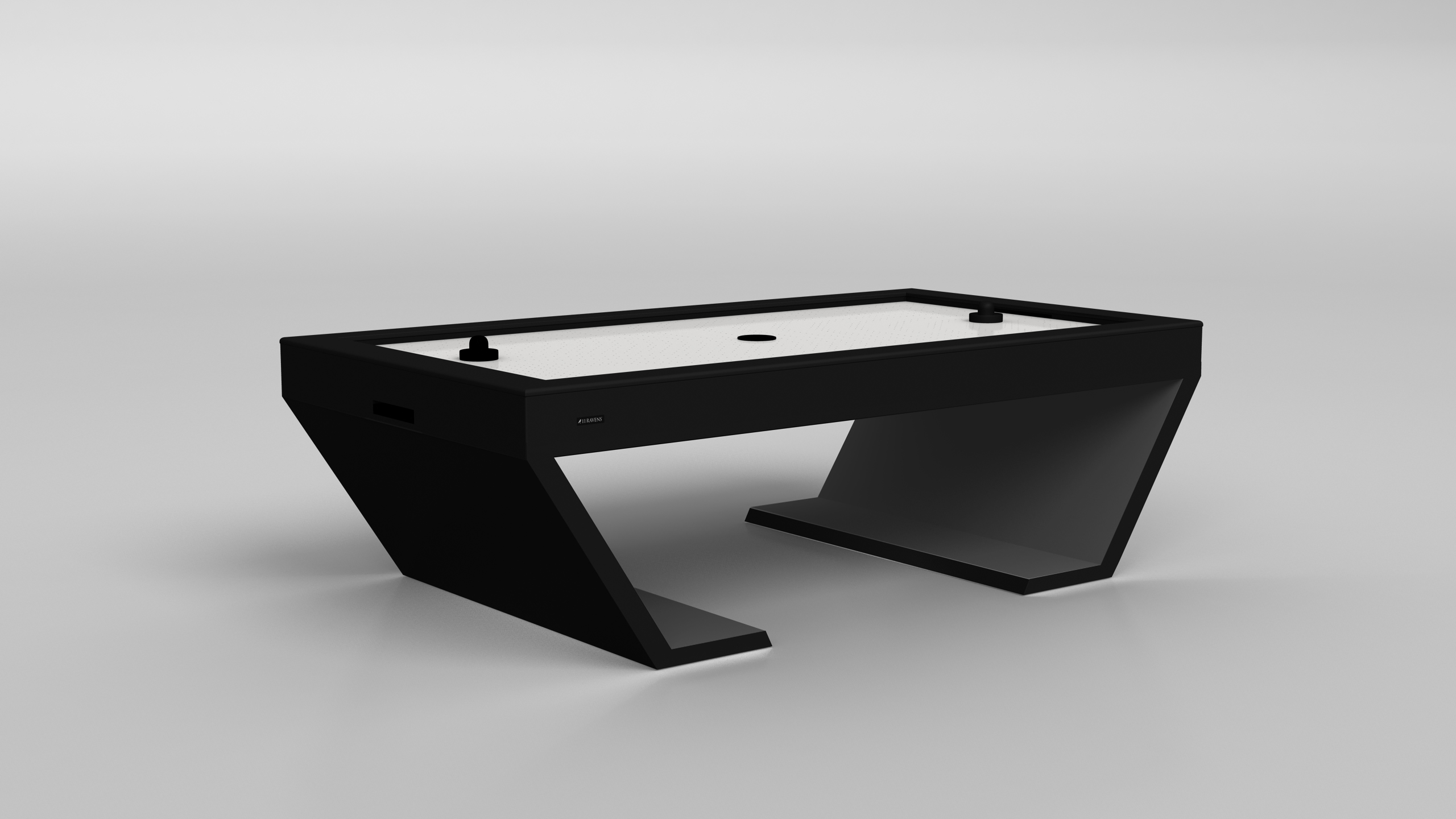 The Cabaret Air Hockey Table features a minimalist black design, angled legs, and a white playing surface with two black pushers and a puck, set against a plain light gray background.
