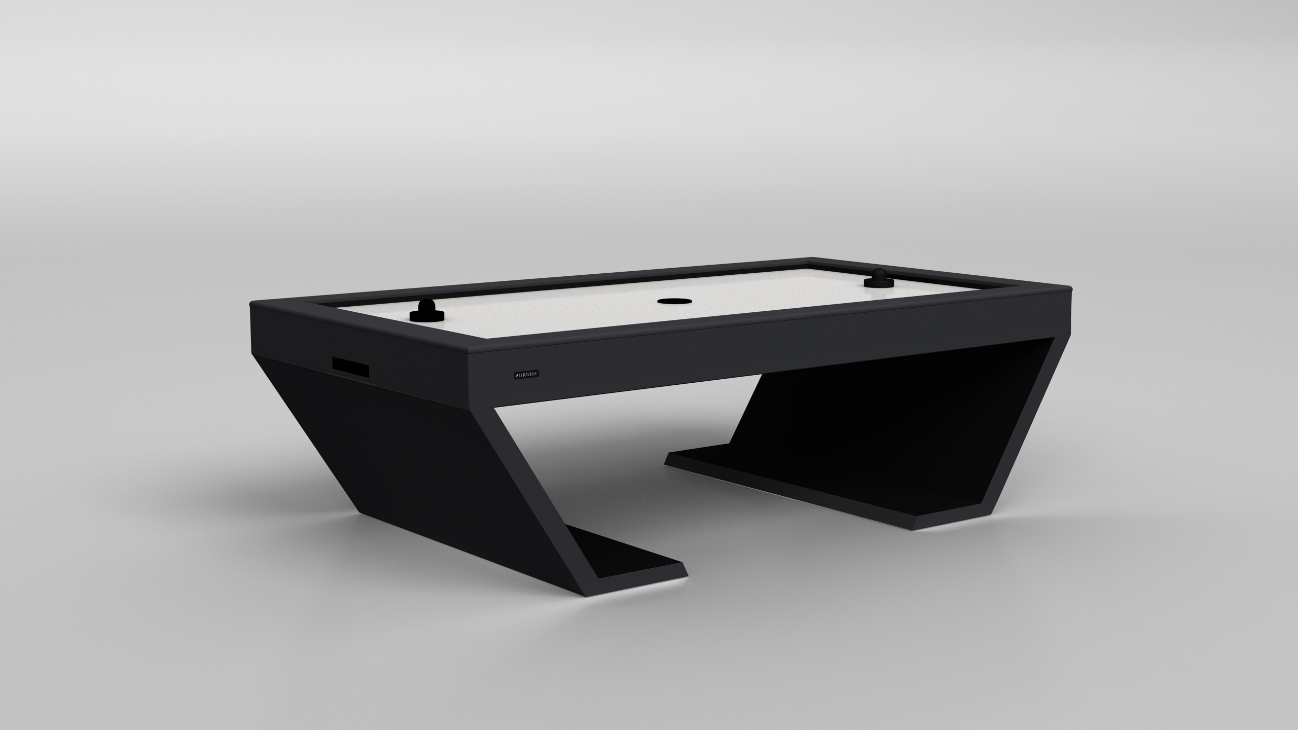 The Cabaret Air Hockey Table features a modern, angular black design with a white playing surface, includes two black paddles and a puck on top, all set against a plain light gray background.