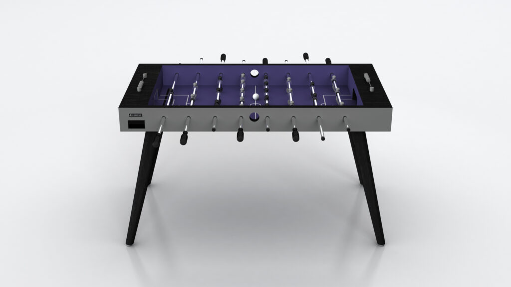 The Hamptons Foosball Table features a modern design with a purple playing field, black legs, and metal rods with black handles, displayed front-facing against a plain white background.