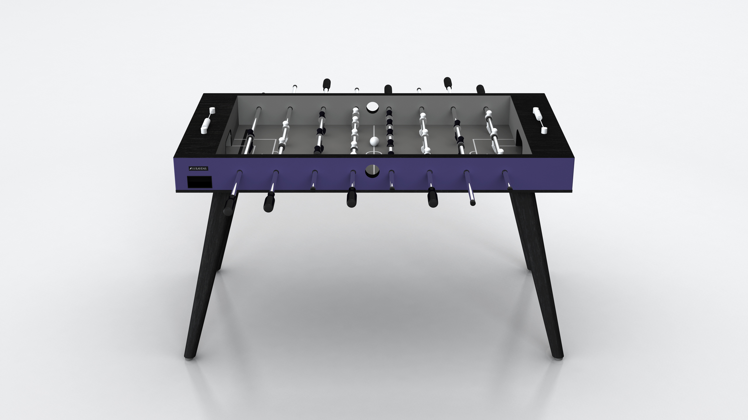 The Hamptons Foosball Table features a modern design with a purple and black frame, silver rods, black and white players, and four angled black legs, displayed against a plain white background.