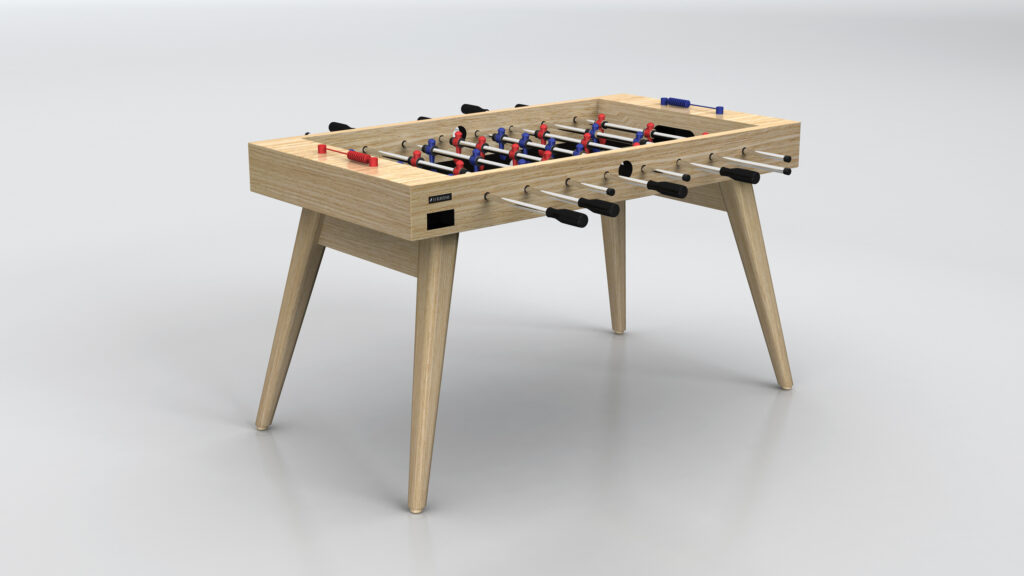 The Hamptons Foosball Table features a modern design with four angled wooden legs and black handles, showcased on a light gray background.