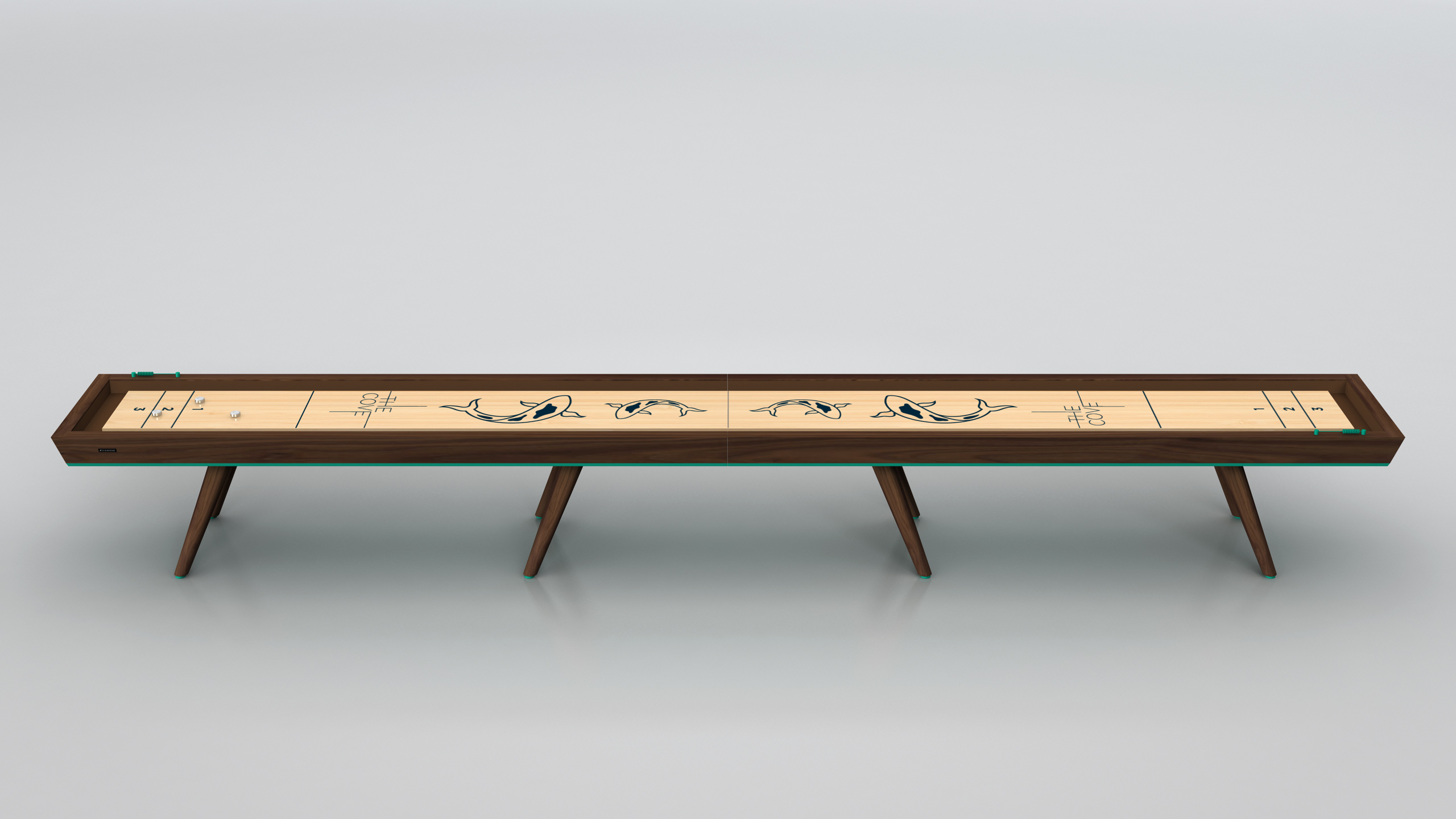 The Hamptons Shuffleboard Table, with its long wooden surface featuring orca designs and three sets of angled legs, stands out beautifully against a simple light background.