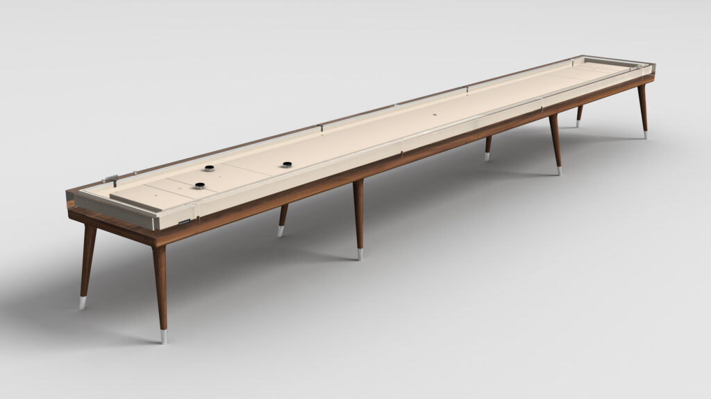 The Hamptons Shuffleboard Table features a modern, long design with a light playing surface, wooden frame, clear side panels, angled legs, and black pucks, all set against a plain white background.