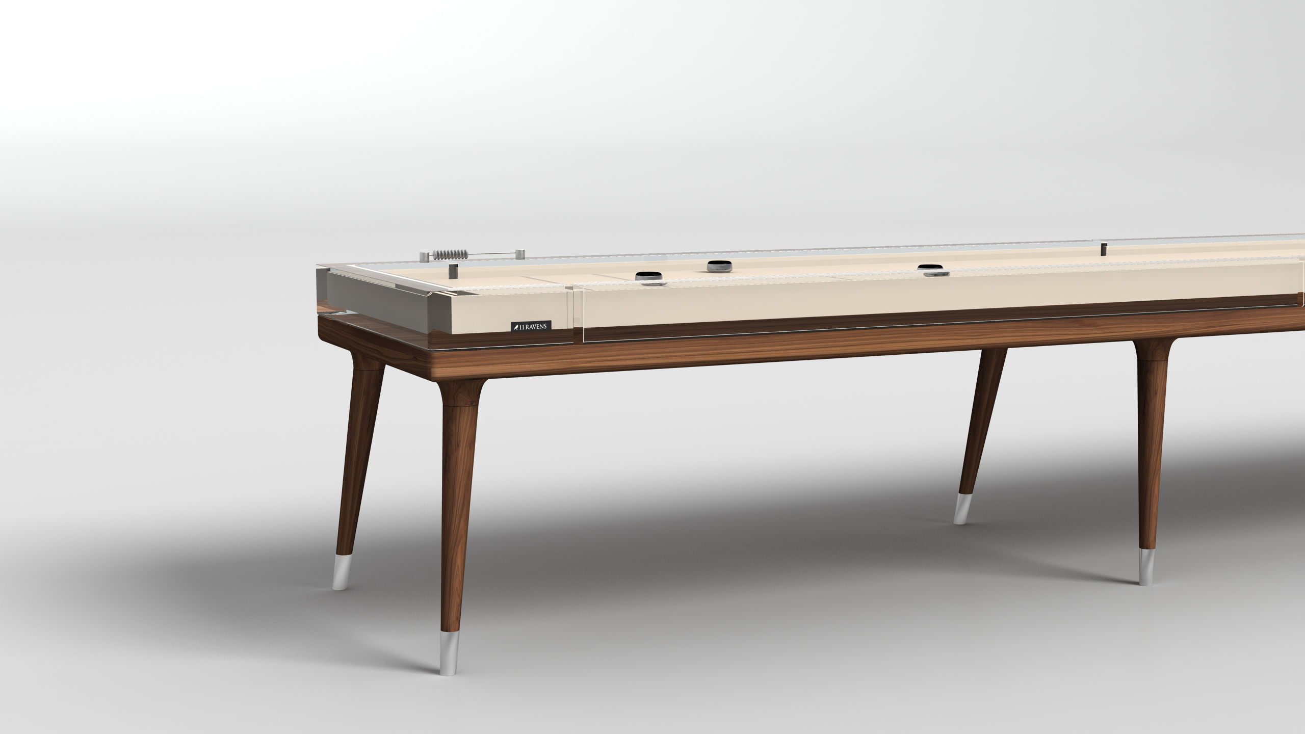 The Hamptons Shuffleboard Table features a wooden frame, sleek tapered legs with metal-capped feet, and a light-colored playing surface with two pucks, adding elegance to any space. Shown on a white background.