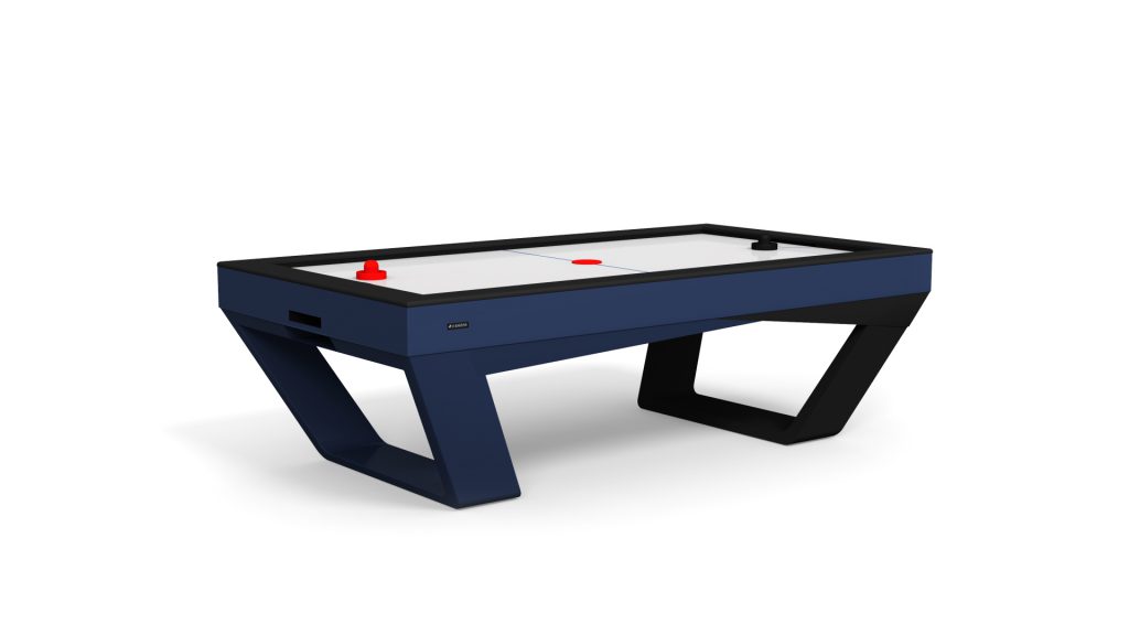 The Avettore Air Hockey Table features a sleek, modern design with a dark blue frame and angled legs. Its white playing surface is highlighted by red and blue lines, accompanied by black and red pucks for hours of refined fun.