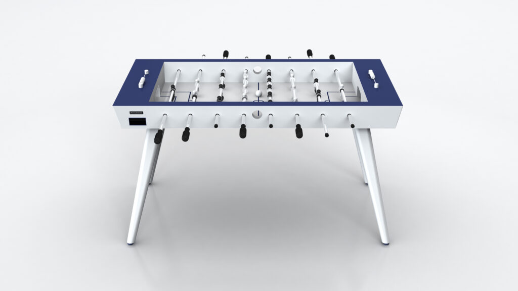 The Hamptons Foosball Table features a modern blue and white design with black and white player figures, black handles, and angled white legs, shown against a plain white background.