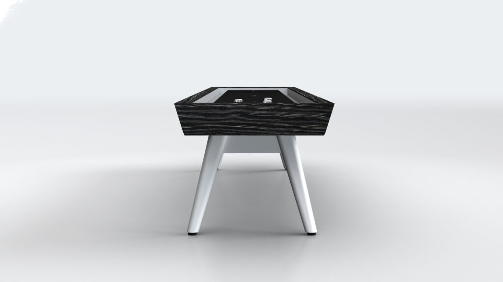 A modern foosball table with a black wood-patterned top and white angled legs, inspired by the elegant Hamptons Shuffleboard Table, viewed from the short end against a plain light background.