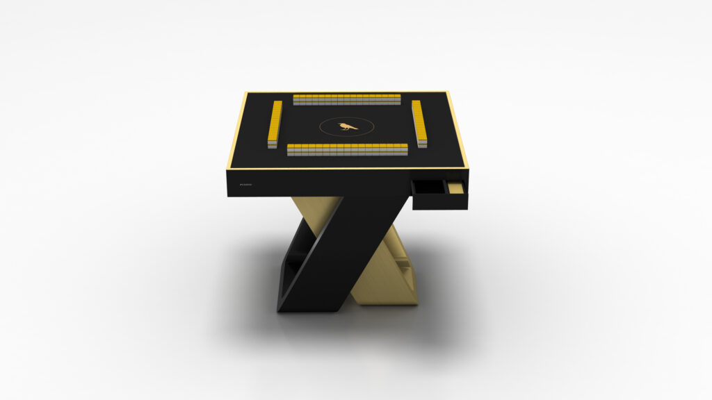 The Theseus Mahjong Table is a sleek, modern luxury game table with a black and gold finish. It features a rectangular top with a central circular emblem and has a unique Z shaped base, making it both functional and an elegant centerpiece on a plain white background.