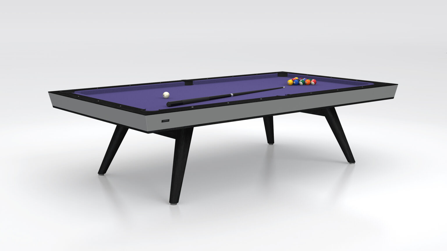 The Hamptons Pool Table exudes luxury with its modern design, featuring a purple felt surface, black legs, and a sleek gray border. A cue stick and white cue ball are ready for play, accompanied by colorful balls arranged in a triangle at the back.