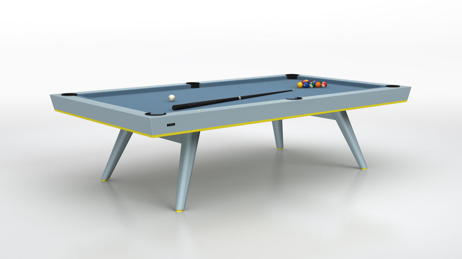 The Hamptons Pool Table, a luxury game table with a modern design and four angled legs, sits on a white floor. It features a blue playing surface, billiard balls arranged at one end, and a cue stick on top.