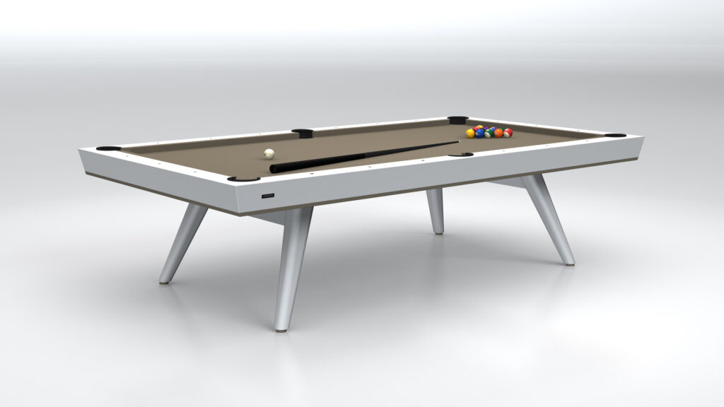 The Hamptons Pool Table, part of a luxury collection, boasts a sleek white frame and beige playing surface. With pool balls neatly arranged and the cue ball positioned separately, its angled legs provide support in a minimalist setting.