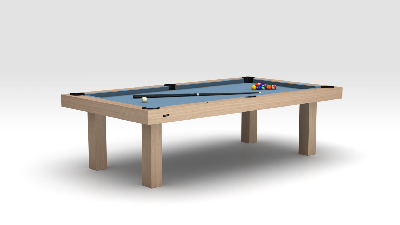The Malibu Pool Table, crafted from rich wood, showcases a light blue felt surface. A cue stick lies next to a white cue ball and a neatly arranged set of billiard balls in a triangle. The understated light gray backdrop enhances the elegant setup.