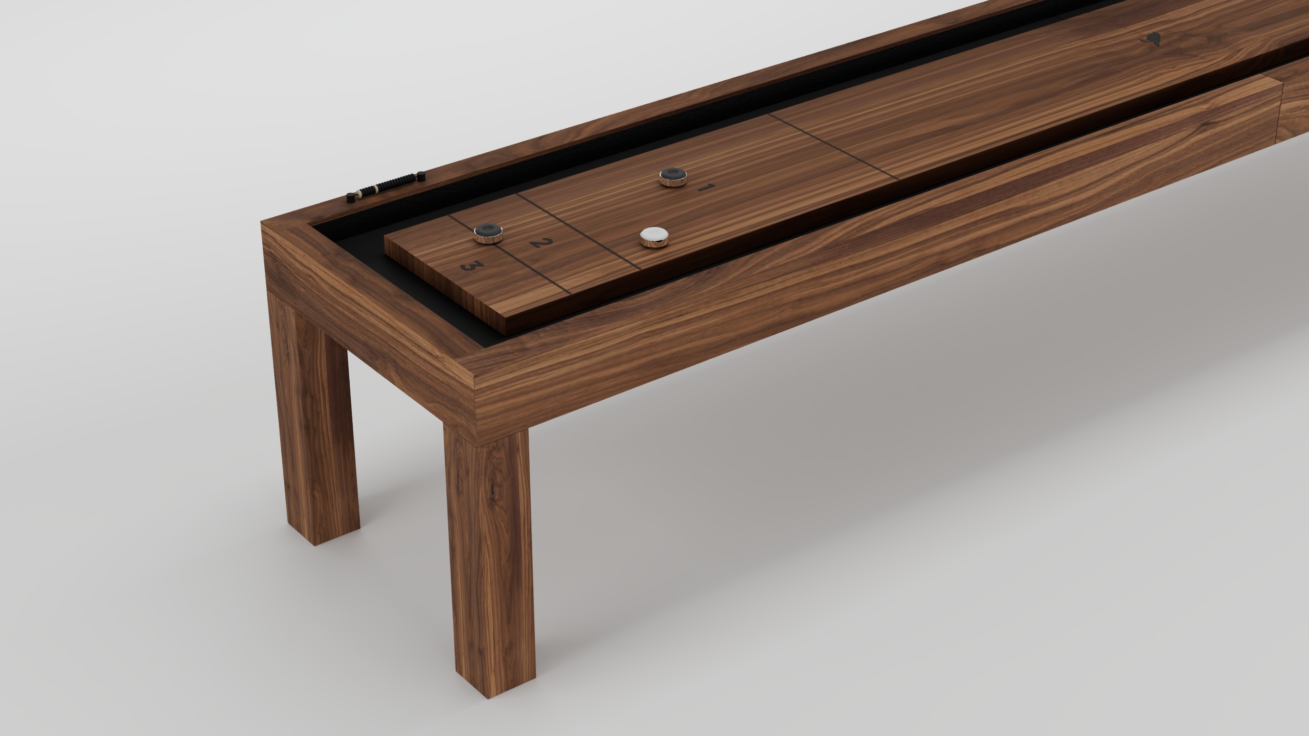 The Malibu Shuffleboard Table features a sleek, minimalist design with a smooth playing surface and several pucks on top, shown against a plain white background.