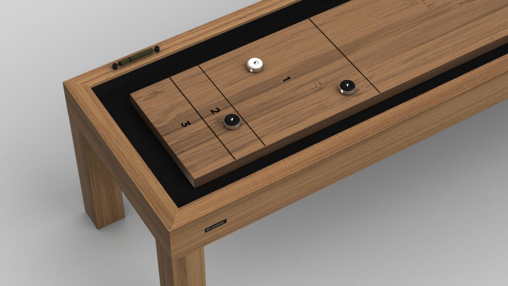 A close-up of the Malibu Shuffleboard Table shows white, black, and silver pucks on scored sections labeled 1, 2, and 3. Its sleek, minimalist design brings a sophisticated touch to any room.