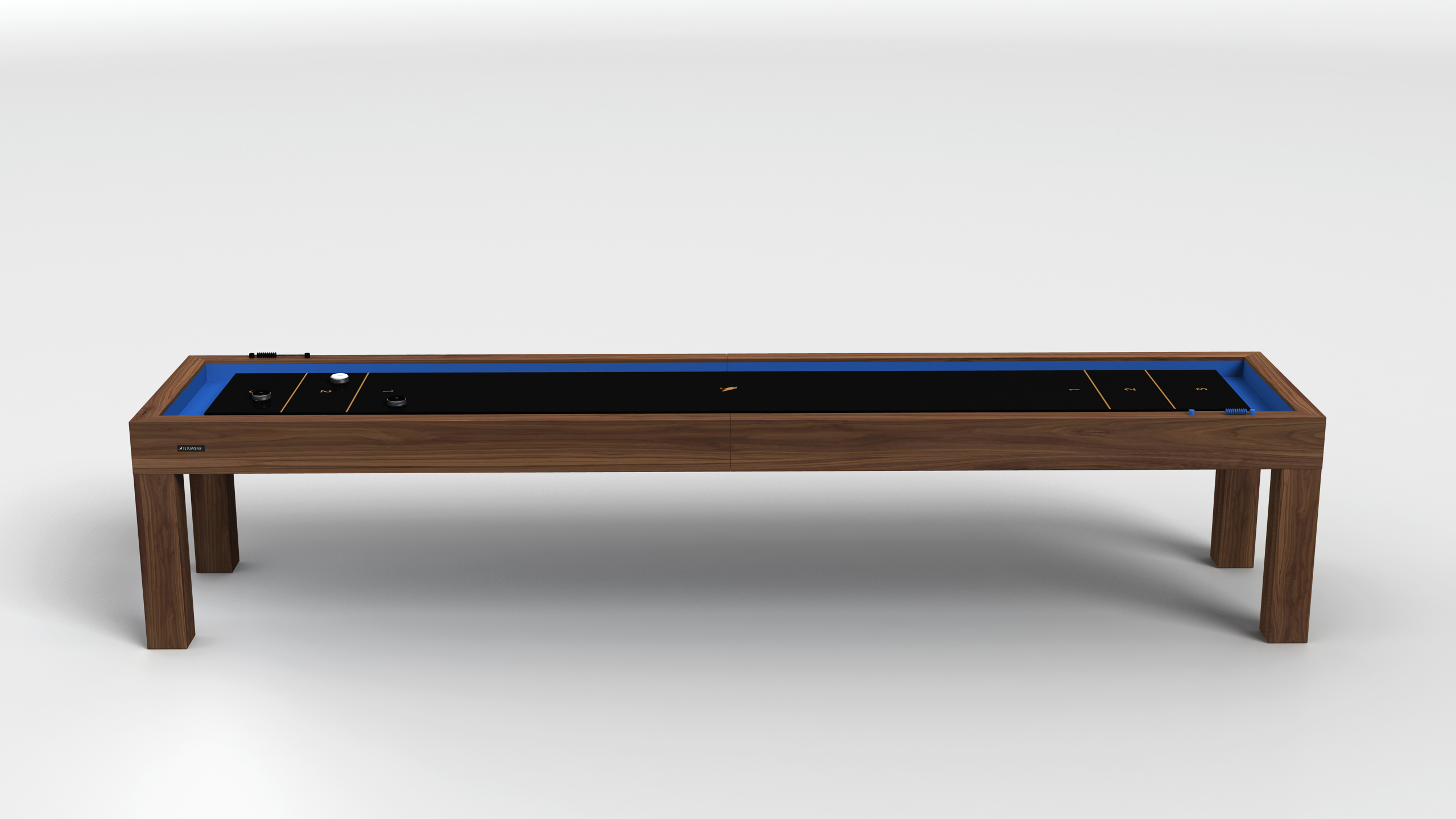 The Malibu Shuffleboard Table features a wooden frame, black playing surface, and blue interior sides, displayed in a minimal, well-lit setting.
