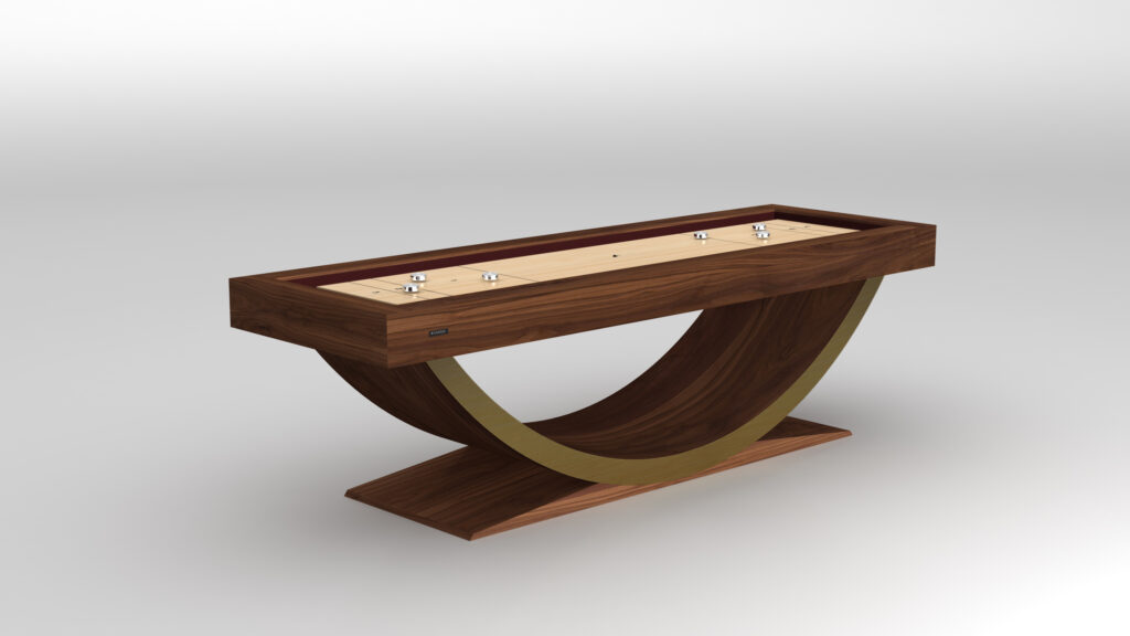 The Theseus Shuffleboard Table showcases a modern wooden playing surface and a distinctive curved wooden and brass base, displayed on a plain white background.
