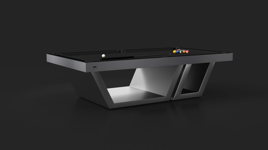 A sleek, modern Titan Pool Table with a minimalist angular base stands against a dark background. Billiard balls and a cue stick are set on the table, ready for play.