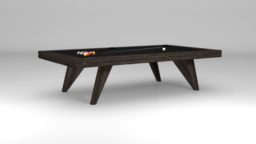 The Trigon Pool Table, featuring a sleek design and dark wooden finish, stands on a gray floor, complete with colorful billiard balls and a white cue ball ready for play.