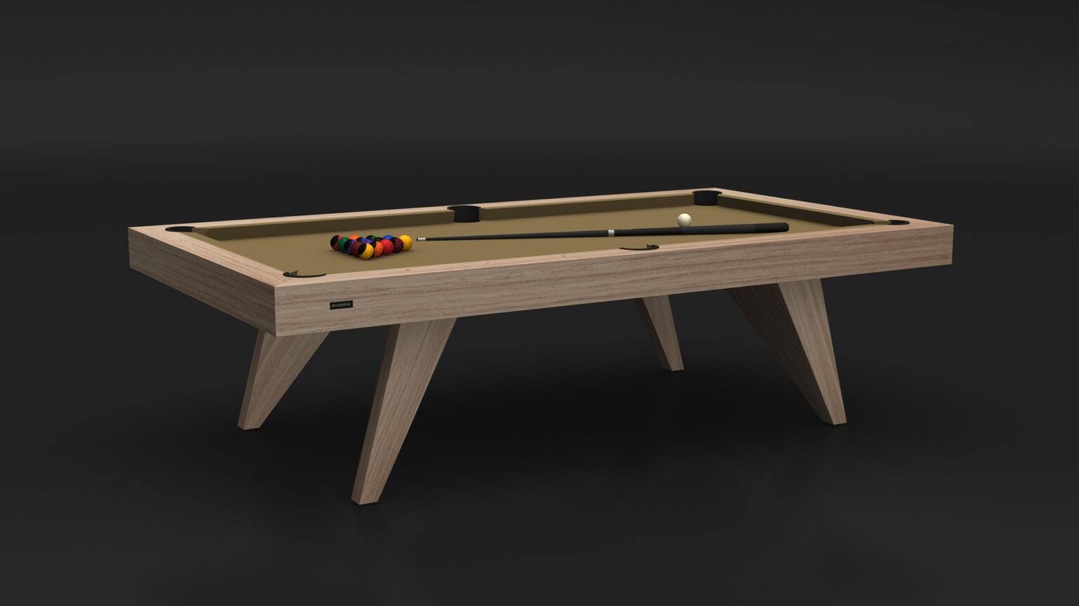 The Trigon Pool Table, featuring a luxury wooden design and tan felt surface, stands in a dimly lit room. A cue stick and rack of colorful billiard balls rest on its sleek, angled legs, adding elegance to any upscale setting.