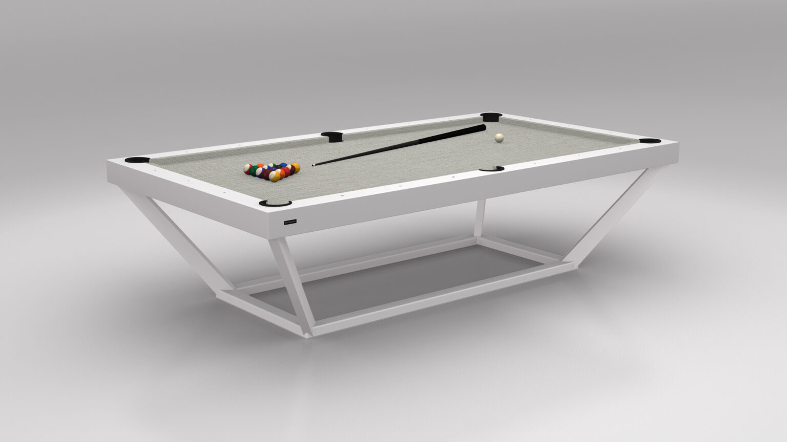 The Vitro Pool Table, a luxurious game table, boasts a white frame and sleek grey surface. It includes a rack of colorful billiard balls, a cue ball, and a cue stick elegantly placed across the table.