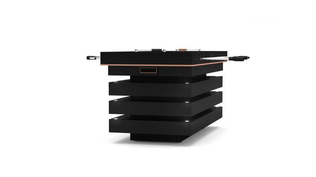 A sleek, black, tower-shaped electronic device with stacked rectangular units and top control knobs and ports, reminiscent of a modern Arclight Foosball Tables minimalist design and striking orange accents.