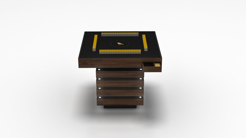 The Theseus Mahjong Table is a modern luxury game table with a sleek black rectangular design, featuring a built-in digital interface with glowing orange indicators. It boasts a wooden base with horizontal panels and includes a side compartment with a visible drawer.