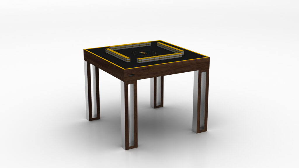 The Executive Mahjong Table features a sleek black surface, wooden frame, metal legs, and built-in yellow-bordered compartments. This modern square table sits elegantly against a white background.