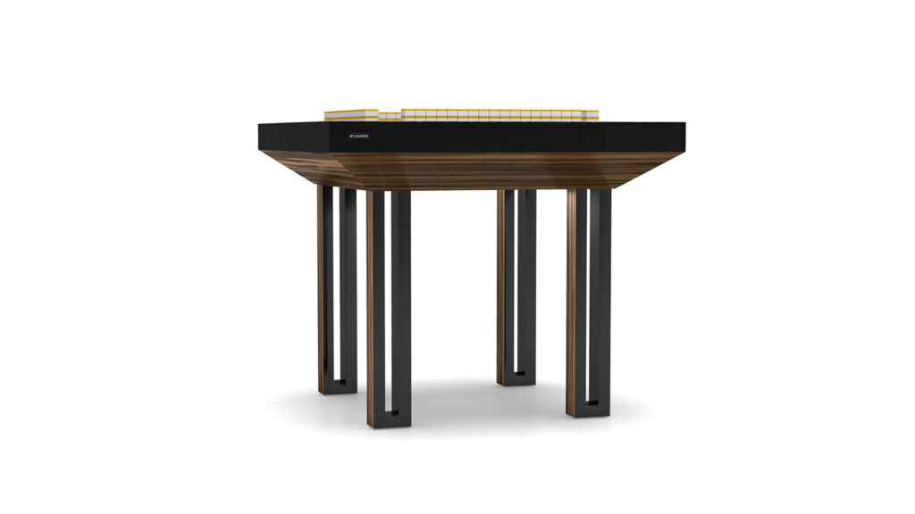 The Executive Mahjong Table features a thick, rectangular wooden top, sleek black sides and legs, plus a small yellow architectural model displayed on one side, all set against a plain white background.