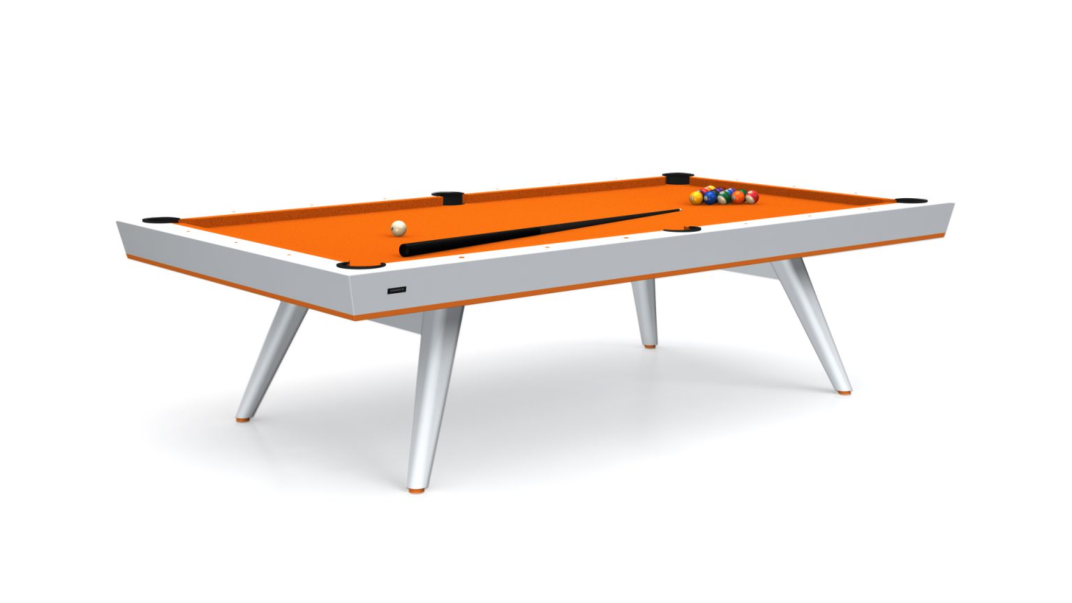 The Hamptons Pool Table, with its orange felt and sleek white legs, exudes elegance. A cue stick lies across, while pool balls are neatly arranged in a triangle at one end, embodying leisure with sophistication.