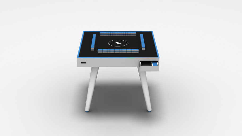 The Theseus Mahjong Table is a modern luxury game table with a sleek black top featuring blue accents and a central circular emblem. It stands on four angled legs and includes a small open drawer, all set against a minimalist backdrop to highlight its elegance.