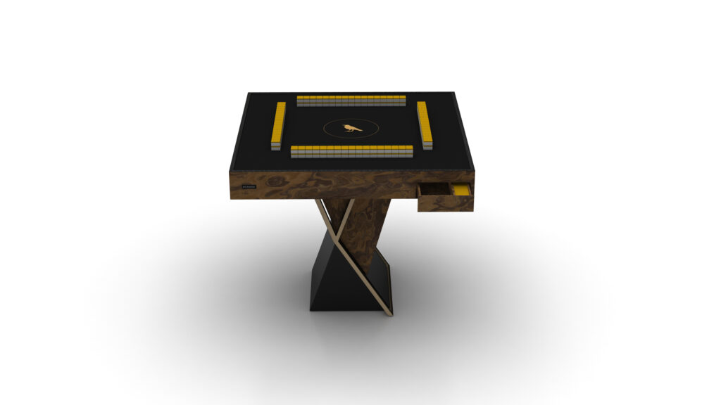 The Theseus Mahjong Table is a square-shaped luxury game table with a sleek black top featuring a centered circular design, an artistic twisted wooden base, and a small side drawer, set against a plain white backdrop.