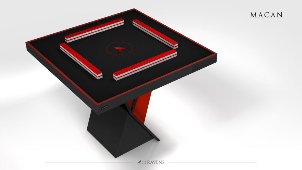 The Macan Mahjong Table features a modern black and red design, a geometric base, four sets of stacked mahjong tiles, and is labeled "MACAN" with the 11 RAVENS brand at the bottom.