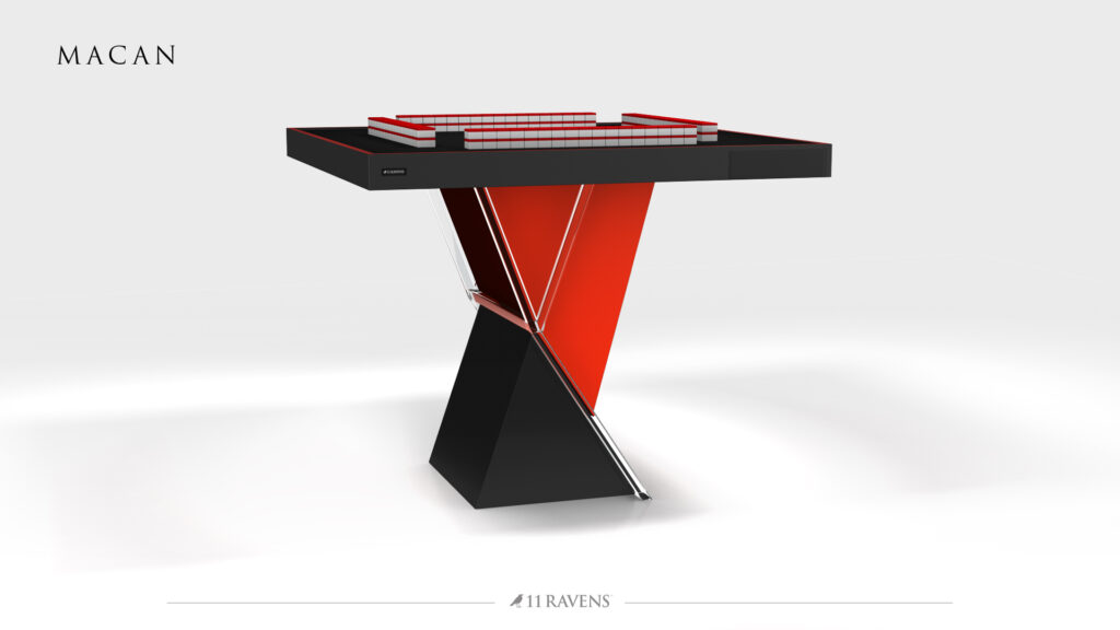 The Macan Mahjong Table boasts a modern design inspired by table tennis, with a bold black-and-red angular base, sleek playing surface, red-bordered net, MACAN at top left, and 11 RAVENS at bottom center.