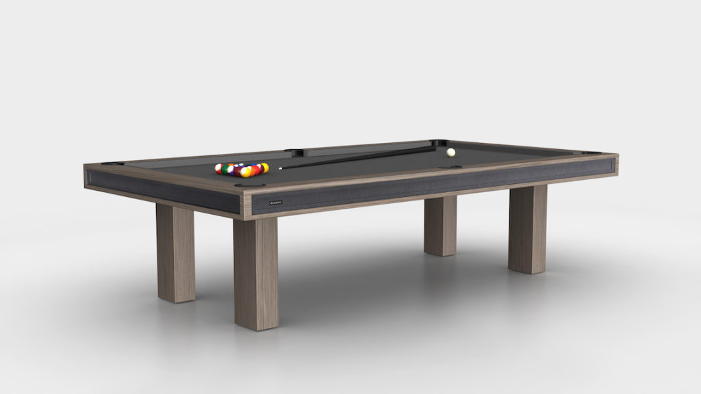 The Malibu Pool Table is a luxury game table featuring a wooden frame with black felt. A set of pool balls is neatly arranged in a triangle with the cue ball nearby, and its sleek design stands out against the minimalist background.