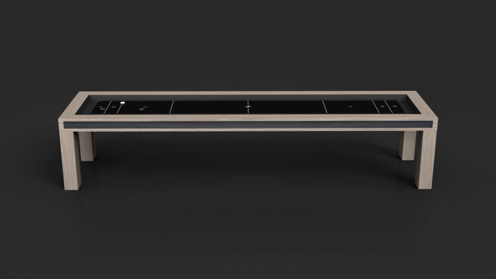 The Malibu Shuffleboard Table features a modern rectangular design with a light wood frame, glossy black surface, minimal white markings, and clean lines. It stands on four sturdy legs and is set against a dark background.