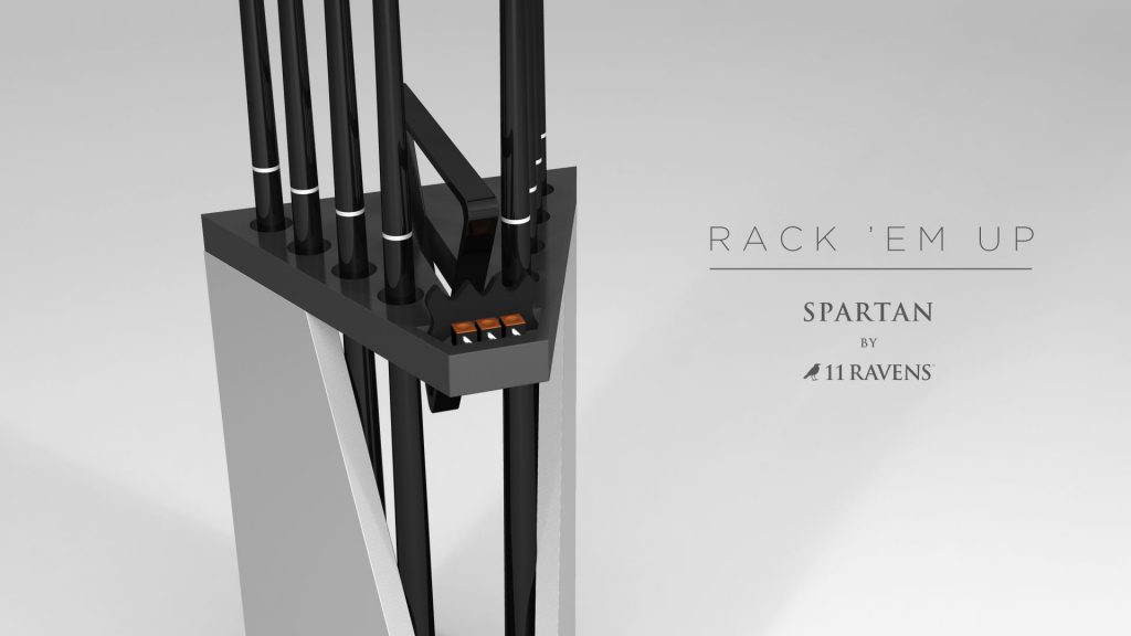 The Spartan Cue Rack features a matte black and gray design with nine cue slots. RACK EM UP and Luxury Spartan by 11 RAVENS adorn the right side. It is set against a neutral background.