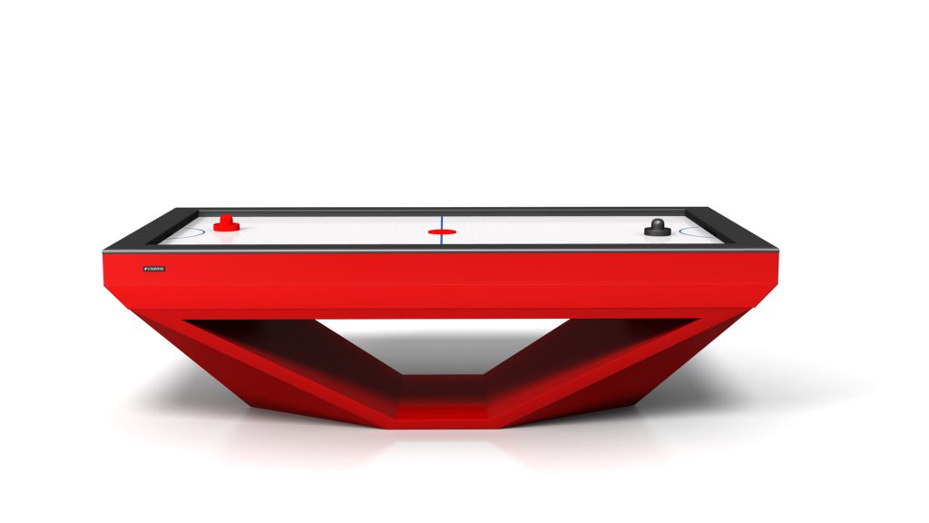 The Stealth Air Hockey Table is a luxurious modern piece with a sleek geometric base, featuring a playing surface with a stealthy center red line and end goals. It includes contrasting black and red paddles ready for play.