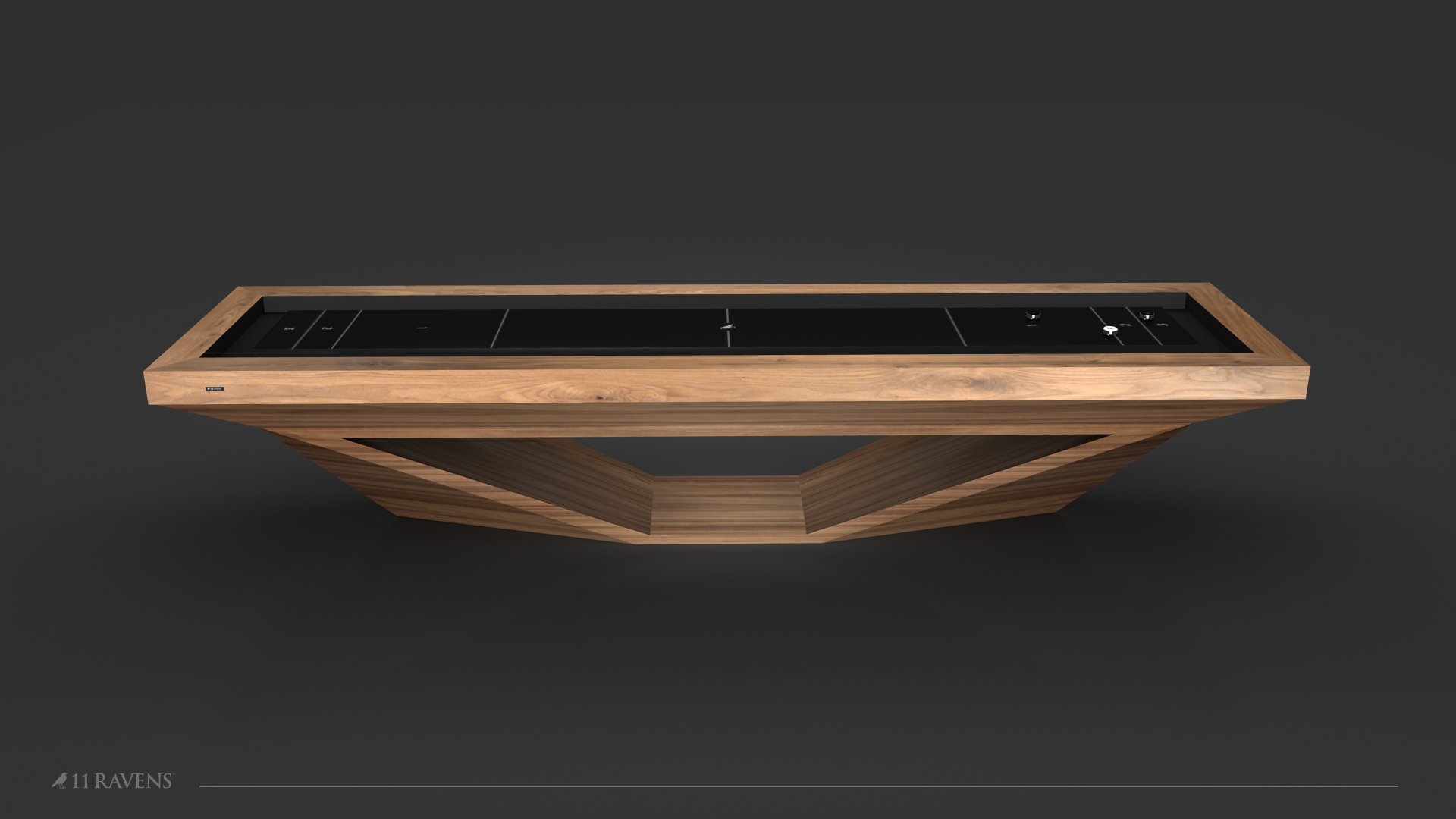 The Stealth Shuffleboard Table features a sleek black playing surface and geometric wooden base, showcased on a dark background with the 11 Ravens logo in the lower left corner.