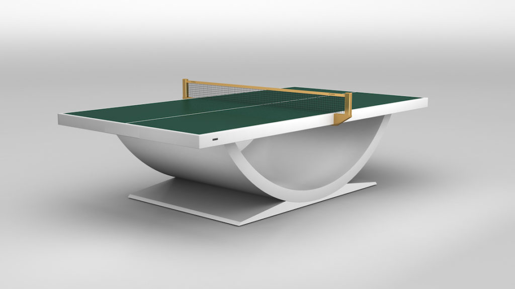 The Theseus Ping Pong Table is a luxurious, modern game table featuring a dark green playing surface, white net, and unique curved base on a white platform. The smooth gradient gray background adds to its elegant appeal.