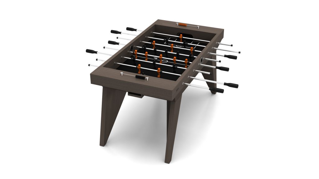 Discover the Trigon Foosball Table, boasting a sleek design with a dark wood finish. Black and silver rods pair with orange players, angular legs, and black handles complete its sturdy build against a clean white backdrop.
