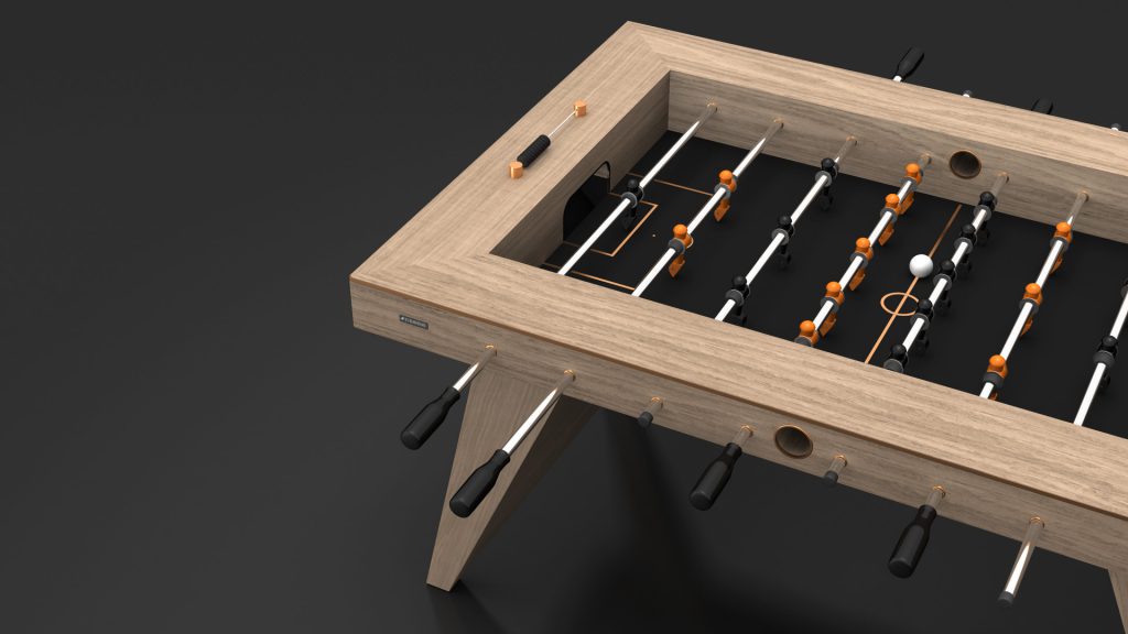 Introducing the Trigon Foosball Table: a sleek modern design with a wooden frame and black legs, featuring orange and black players, a white ball, and black handles that elegantly complement its minimalist look.