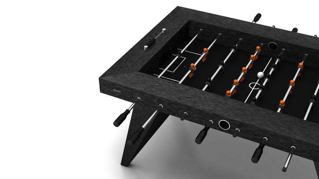 The Trigon Foosball Table is shown in black with metal rods and orange player figures, viewed from an angled top perspective on a white background. A white ball rests on the playing field.
