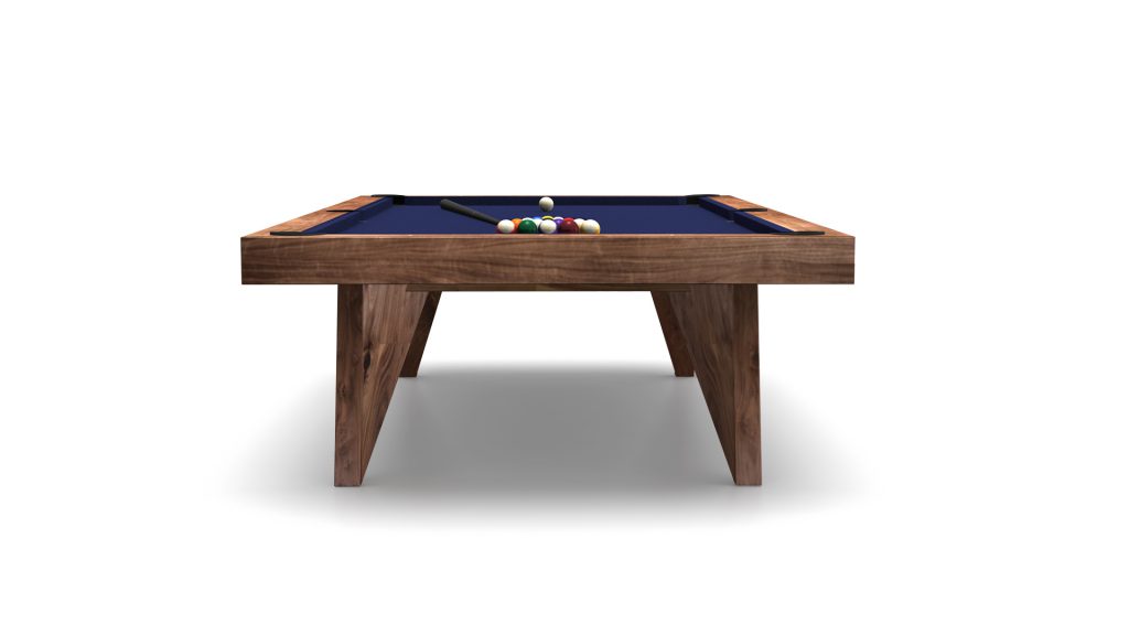 The Trigon Pool Table, featuring a blue felt surface, rests elegantly on a white backdrop. Neatly arranged pool balls and a cue stick accentuate its sophisticated design.